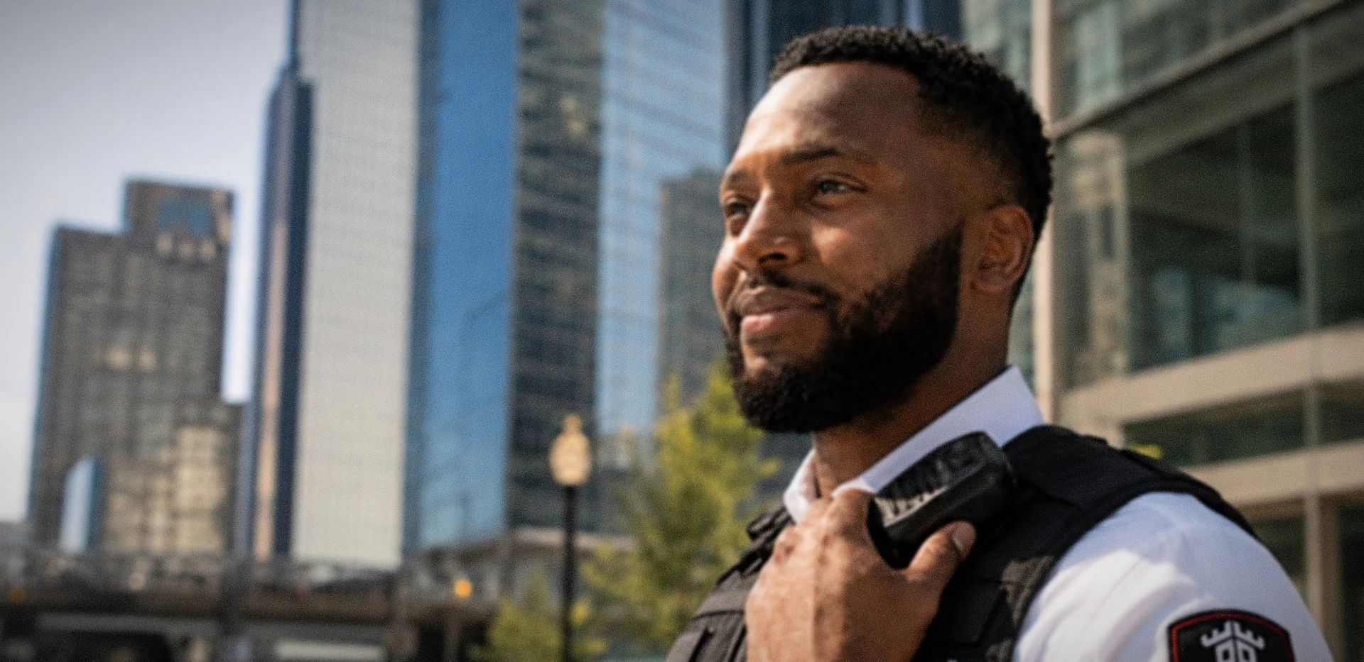 Professional security guard standing in front of downtown Toronto office towers