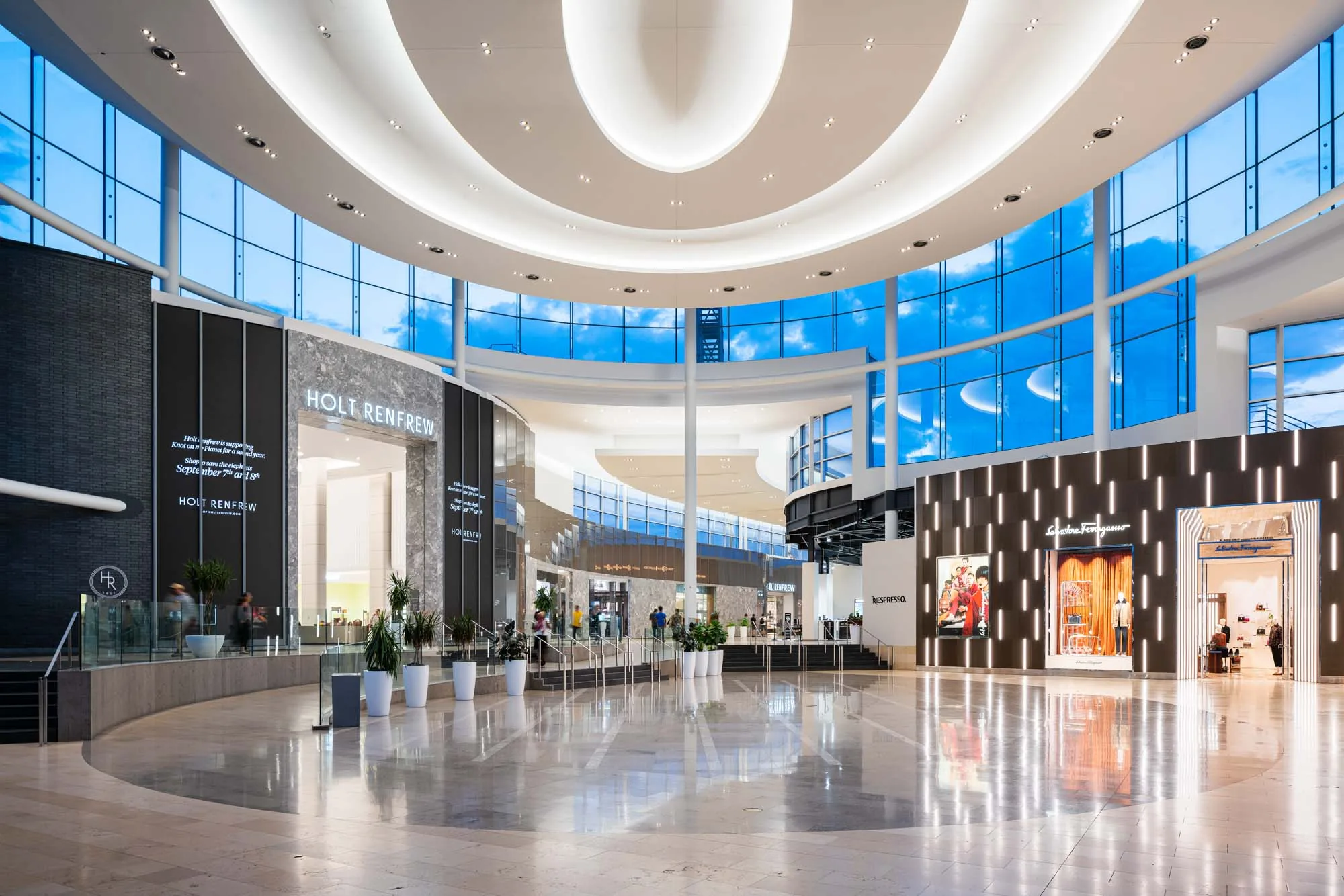 Upscale shopping mall interior with polished floors and luxury storefronts
