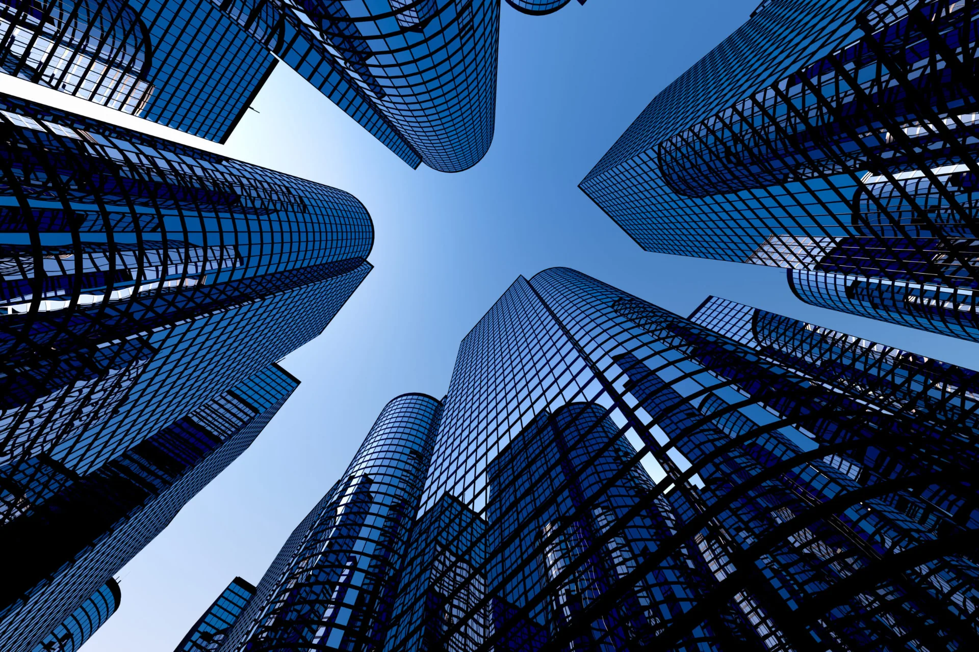 Modern glass skyscrapers towering against a clear blue sky